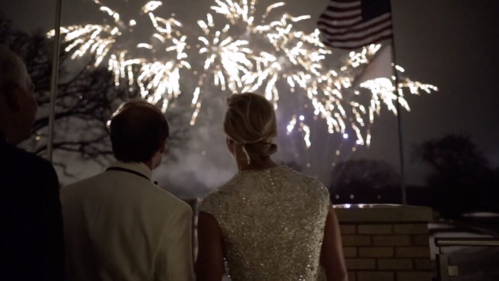 A couple enjoy fireworks at a winter wedding reception held at the North Shore Country Club.