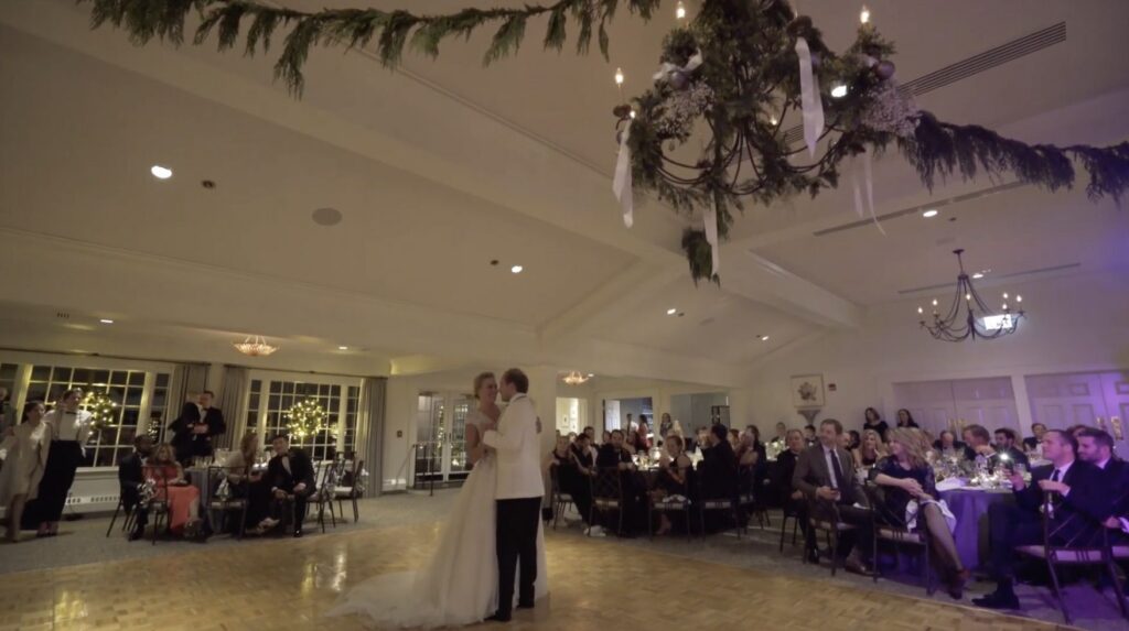 A couple dance their first dance at a winter wedding reception held at the North Shore Country Club.