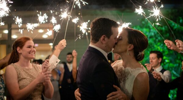 The bride and groom kiss under the stars at their Oak Brook wedding.