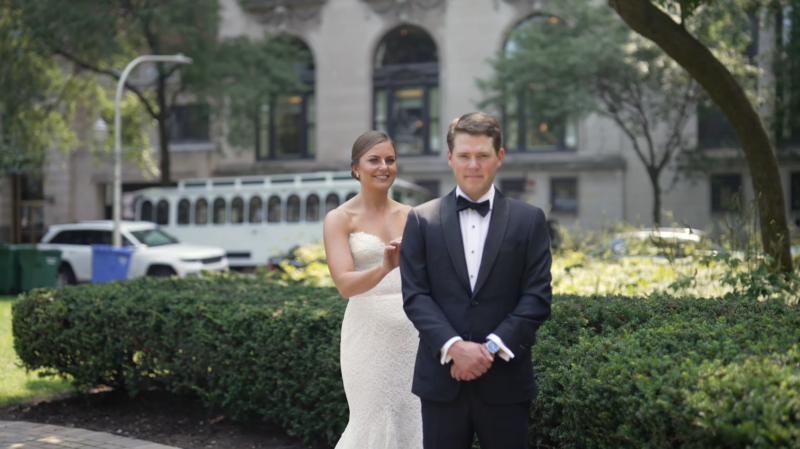 The trolley wedding transport in the background is the first thing you see in this picture of a wedding in Chicago.