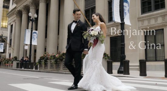 The bride and groom are walking along La Salle Street in Chicago, with the Federal Reserve Bank of Chicago in the background.