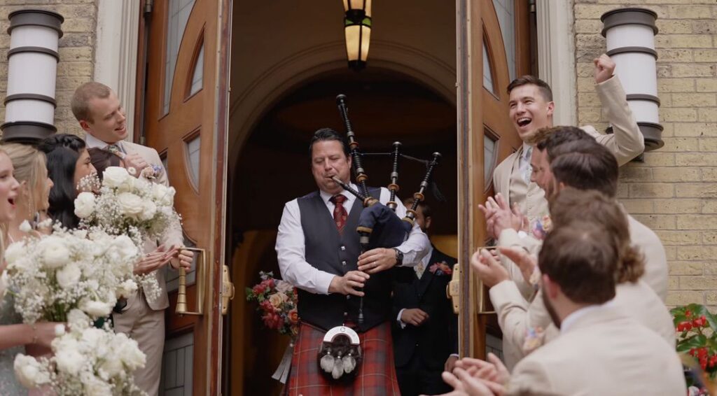 A bagpiper leads the bride and groom outside Old St. Patrick's Catholic Church in Chicago.